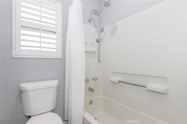 bathroom featuring shower / bath combo with shower curtain and toilet