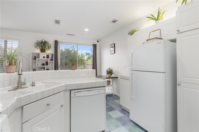 kitchen featuring white cabinetry, tile counters, white appliances, and plenty of natural light