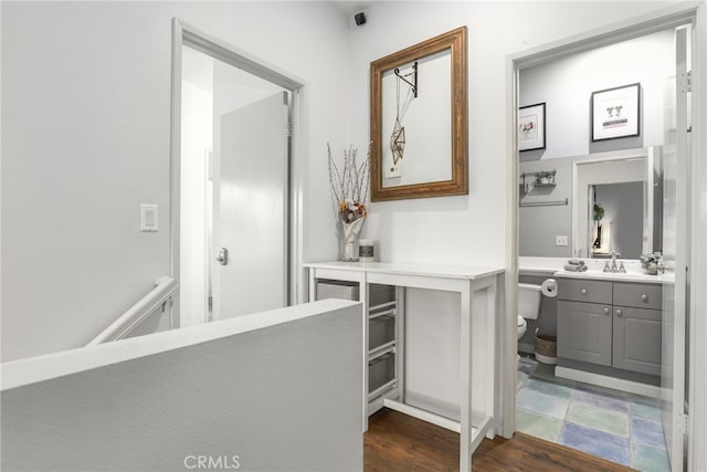 bathroom featuring toilet, hardwood / wood-style floors, and vanity