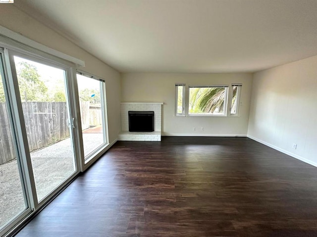 unfurnished living room featuring dark hardwood / wood-style floors and a fireplace