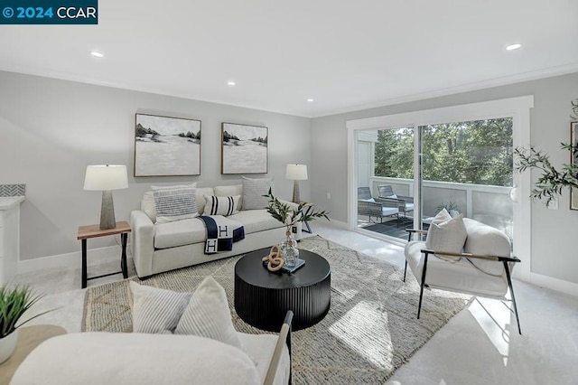 carpeted living room with ornamental molding