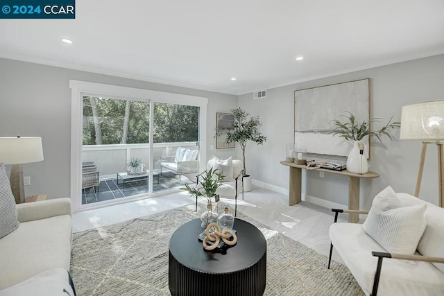 living room with crown molding and light colored carpet