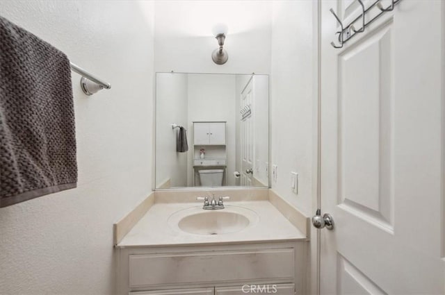 bathroom featuring vanity and toilet