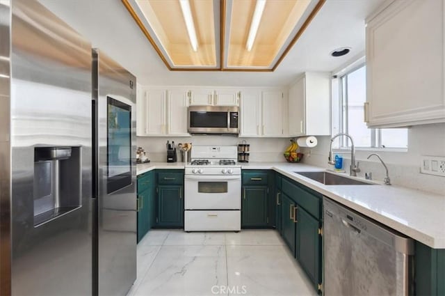 kitchen featuring green cabinets, white cabinetry, sink, and appliances with stainless steel finishes