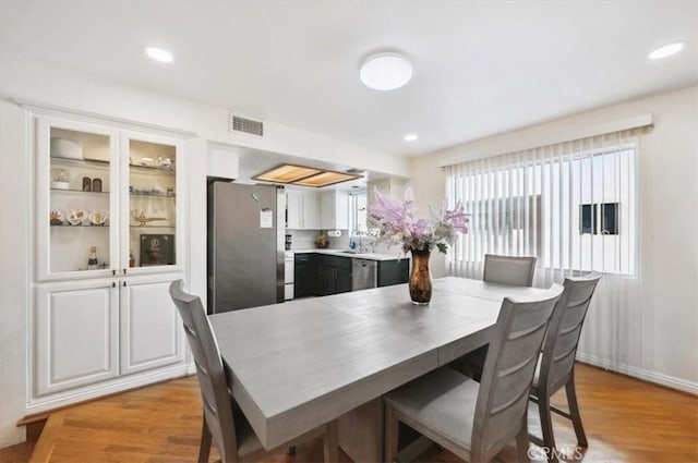 dining area featuring light hardwood / wood-style flooring and sink