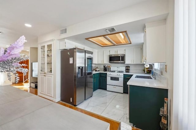 kitchen with sink, white cabinets, and stainless steel appliances