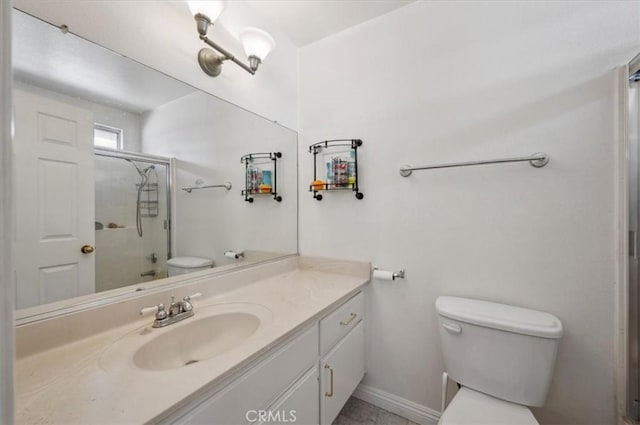 bathroom featuring vanity, toilet, and a shower with door