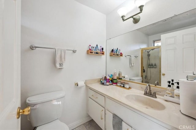 bathroom with vanity, toilet, and a shower with shower door