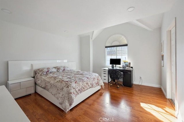 bedroom featuring hardwood / wood-style flooring and vaulted ceiling