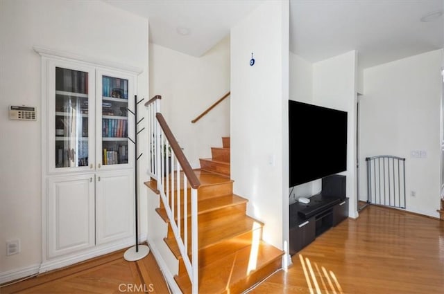 stairs featuring hardwood / wood-style floors