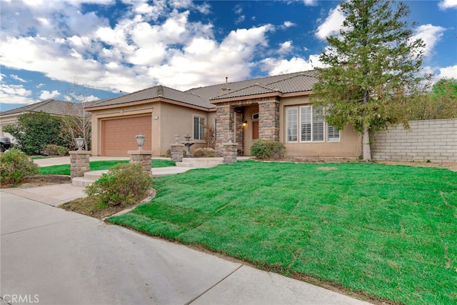 view of front of house with a front yard and a garage