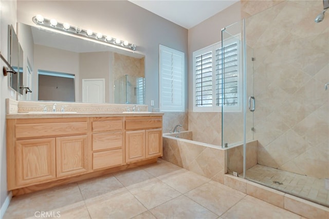 bathroom featuring vanity, shower with separate bathtub, and tile patterned flooring