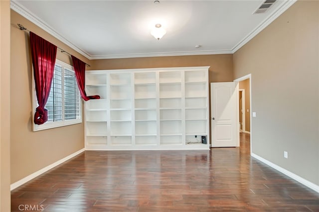 spare room featuring crown molding and dark hardwood / wood-style floors