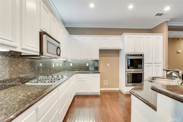 kitchen with white cabinetry, stainless steel appliances, and sink