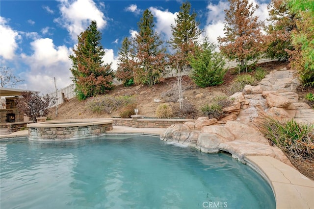 view of swimming pool with an in ground hot tub and pool water feature