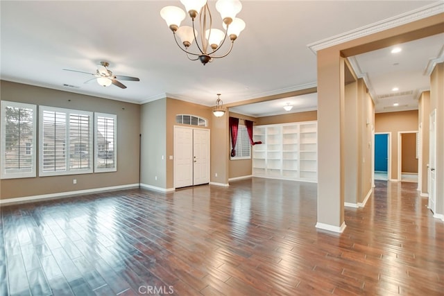 empty room with crown molding, ceiling fan with notable chandelier, and dark hardwood / wood-style flooring