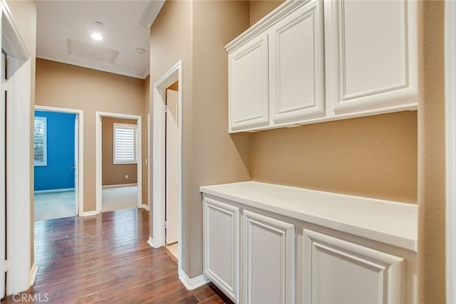 hallway featuring ornamental molding and dark hardwood / wood-style floors