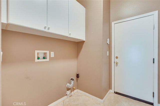 laundry area featuring washer hookup, light tile patterned floors, and cabinets