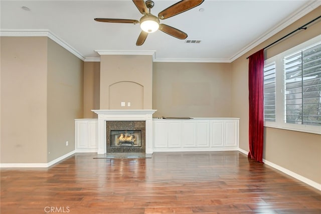 unfurnished living room featuring ornamental molding, a high end fireplace, hardwood / wood-style flooring, and ceiling fan