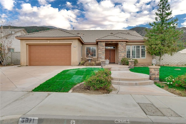 view of front of property featuring a mountain view and a garage