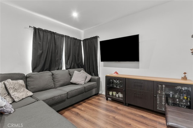 living room featuring dark wood-type flooring and bar