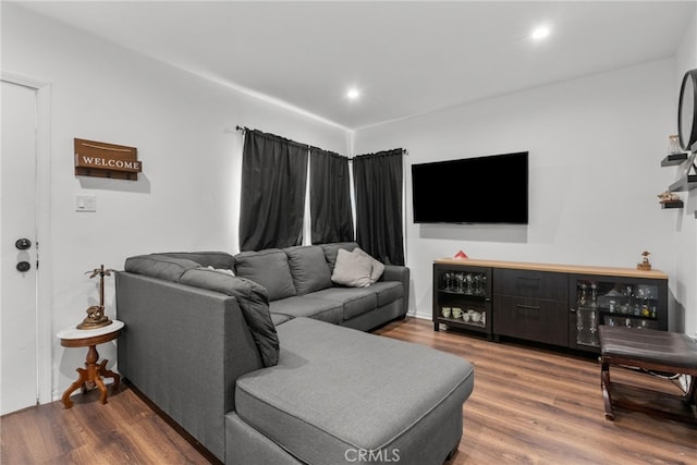 living room with indoor bar and wood-type flooring