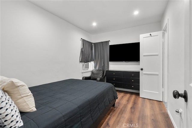 bedroom with cooling unit and dark wood-type flooring