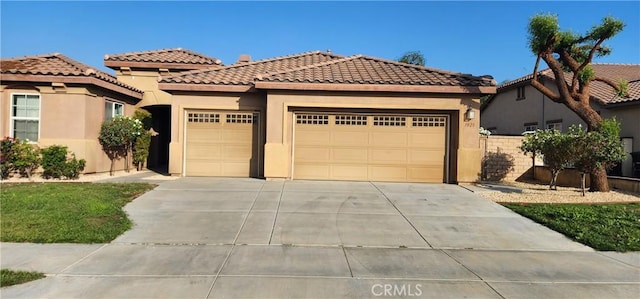 mediterranean / spanish home with a garage