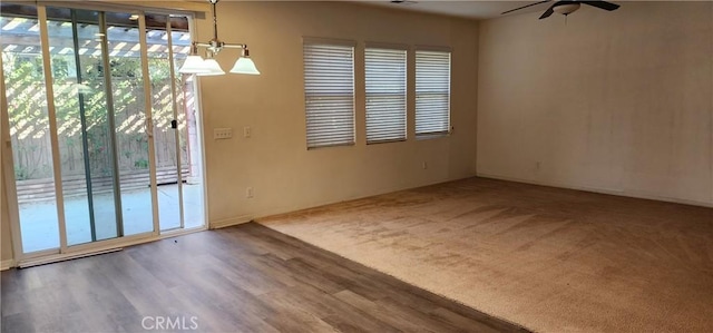 empty room featuring ceiling fan and wood-type flooring