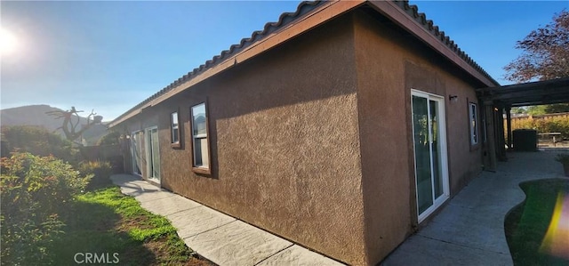 view of property exterior featuring a pergola