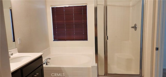 bathroom featuring vanity and independent shower and bath