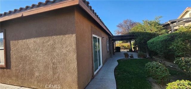 view of side of home featuring a pergola