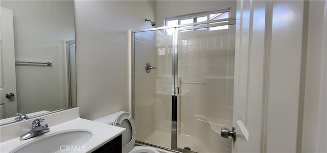 bathroom with an enclosed shower, vanity, and toilet