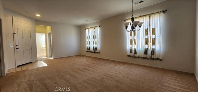 unfurnished dining area featuring light colored carpet and a notable chandelier