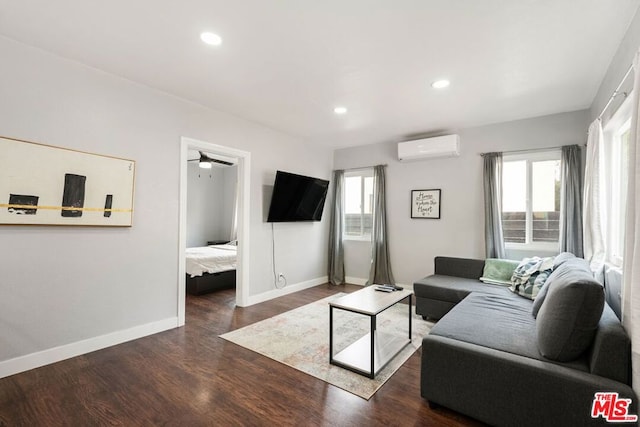 living room featuring an AC wall unit, ceiling fan, and dark hardwood / wood-style floors