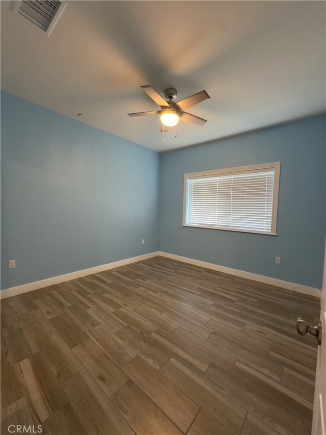 empty room featuring dark hardwood / wood-style floors and ceiling fan