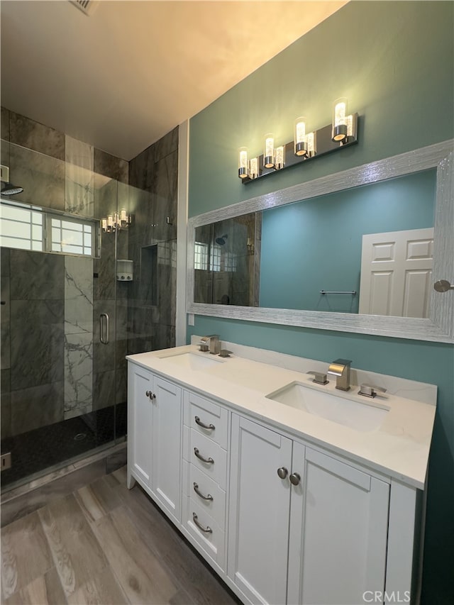 bathroom featuring vanity, walk in shower, and hardwood / wood-style floors