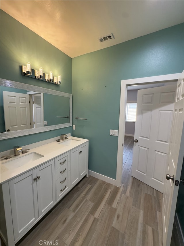 bathroom with vanity and hardwood / wood-style floors