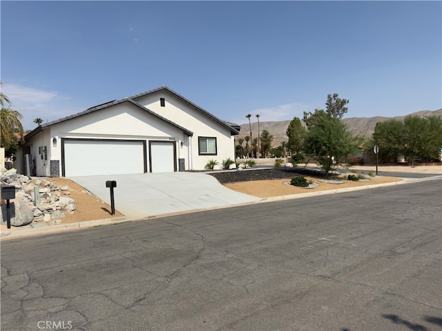 view of front of property featuring a mountain view and a garage