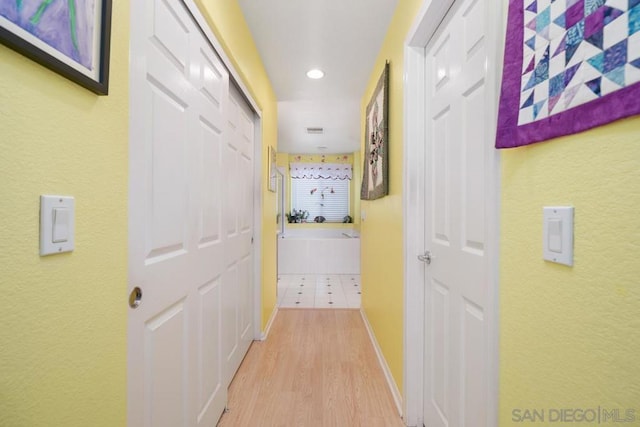 corridor with light hardwood / wood-style flooring