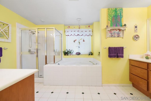 bathroom with vanity and shower with separate bathtub