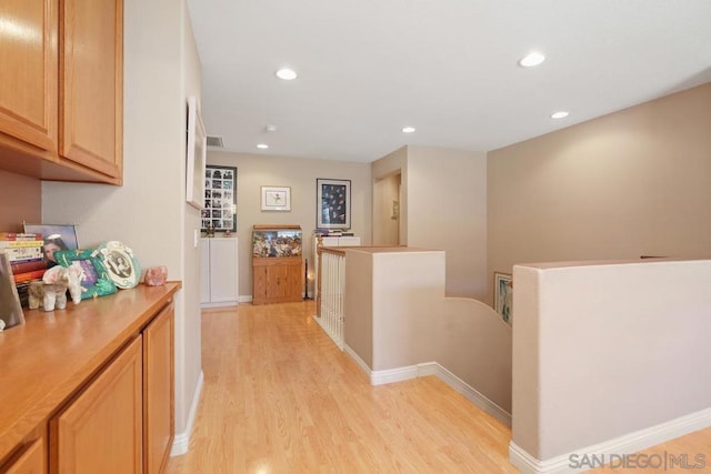 corridor with light hardwood / wood-style flooring