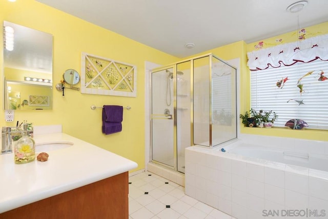 bathroom with vanity, tile patterned floors, and shower with separate bathtub