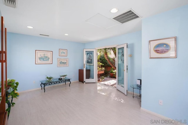 interior space featuring french doors and light hardwood / wood-style floors