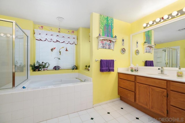 bathroom with vanity, shower with separate bathtub, and tile patterned floors