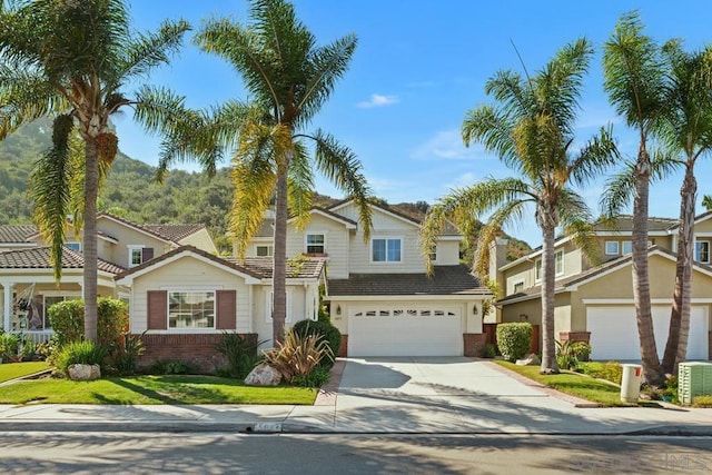 view of front of property with a mountain view, cooling unit, and a front lawn