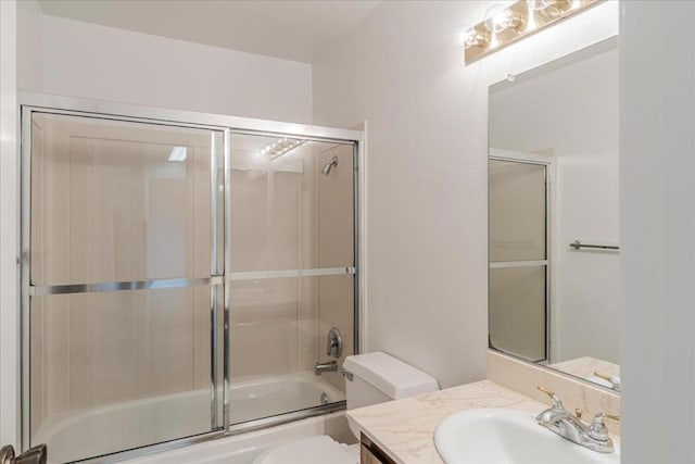 full bathroom with shower / bath combination with glass door, vanity, and toilet