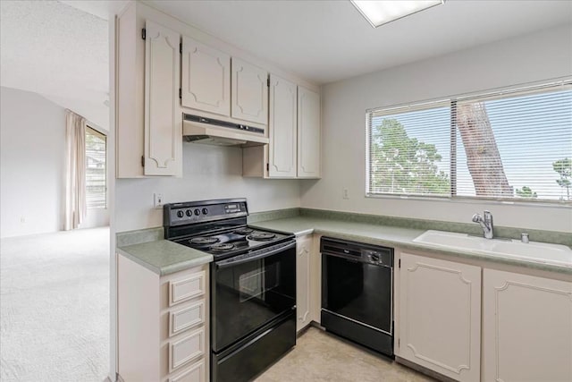 kitchen with black appliances, white cabinets, sink, and light carpet