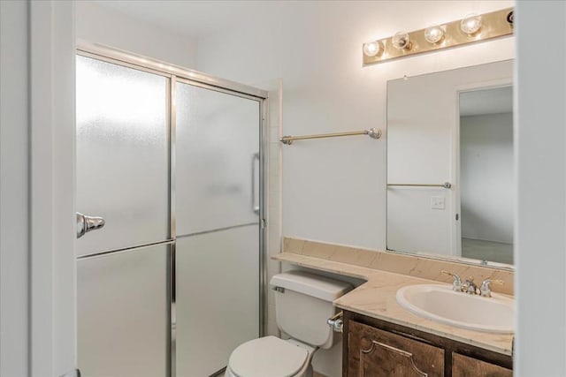 bathroom with vanity, an enclosed shower, and toilet