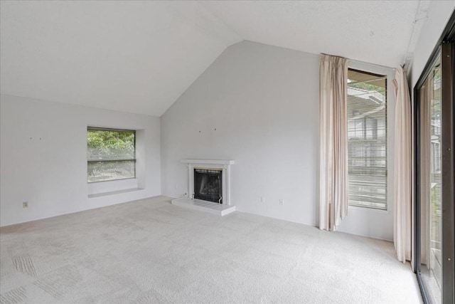 unfurnished living room featuring light colored carpet and lofted ceiling